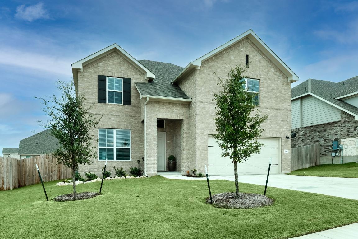 187 Glass Mountain Way Dripping Springs, TX 78620 - Photo 1 of 35 a front view of house with a garden and plants