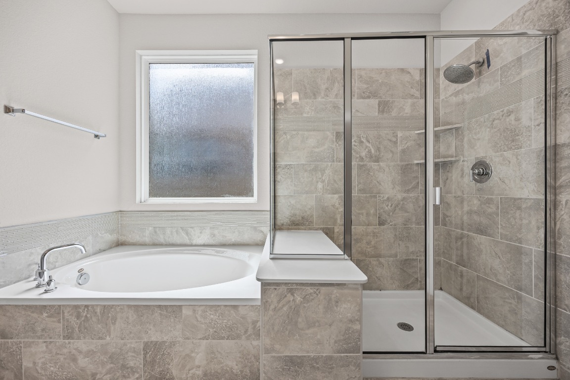 187 Glass Mountain Way Dripping Springs, TX 78620 - Photo 18 of 35 a bathroom with a bathtub and a shower