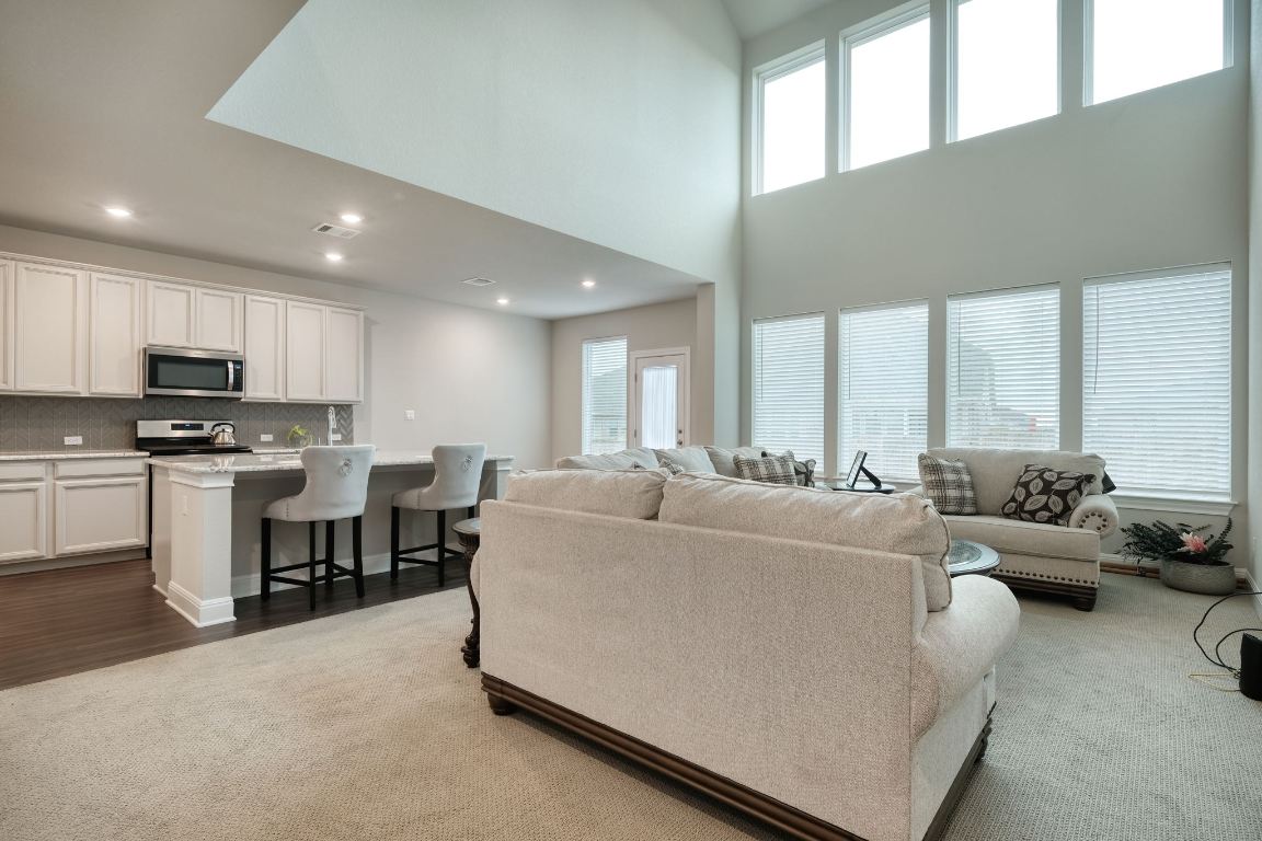 187 Glass Mountain Way Dripping Springs, TX 78620 - Photo 2 of 35 a living room with furniture and a large window