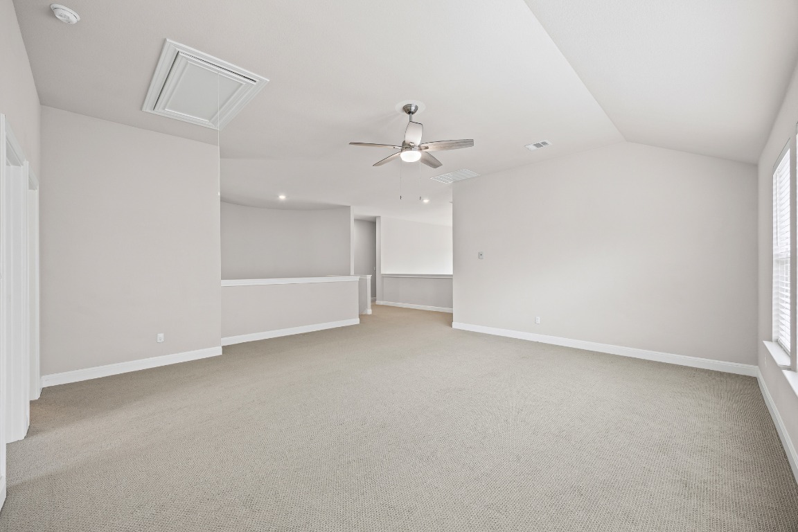 187 Glass Mountain Way Dripping Springs, TX 78620 - Photo 22 of 35 wooden floor in an empty room with a ceiling fan