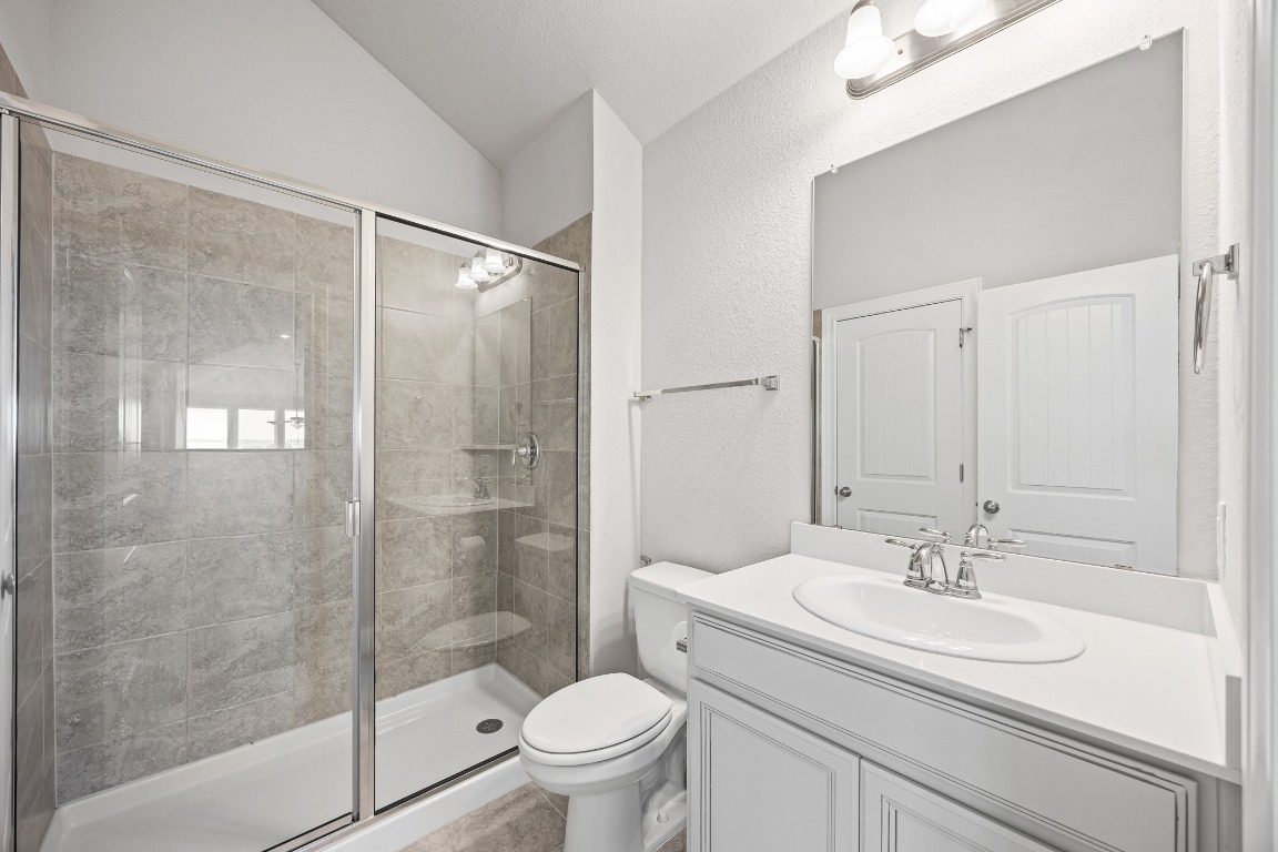 187 Glass Mountain Way Dripping Springs, TX 78620 - Photo 25 of 35 a bathroom with a sink toilet and shower