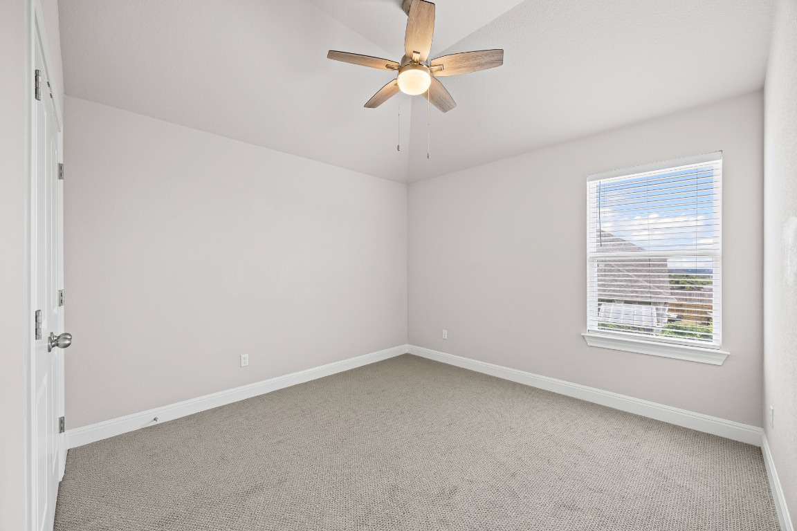 187 Glass Mountain Way Dripping Springs, TX 78620 - Photo 27 of 35 an empty room with a window and a fan
