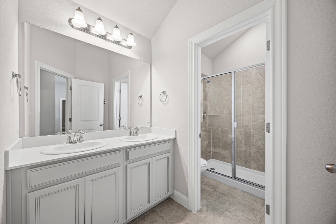 187 Glass Mountain Way Dripping Springs, TX 78620 - Photo 28 of 35 a bathroom with a double vanity sink mirror and shower