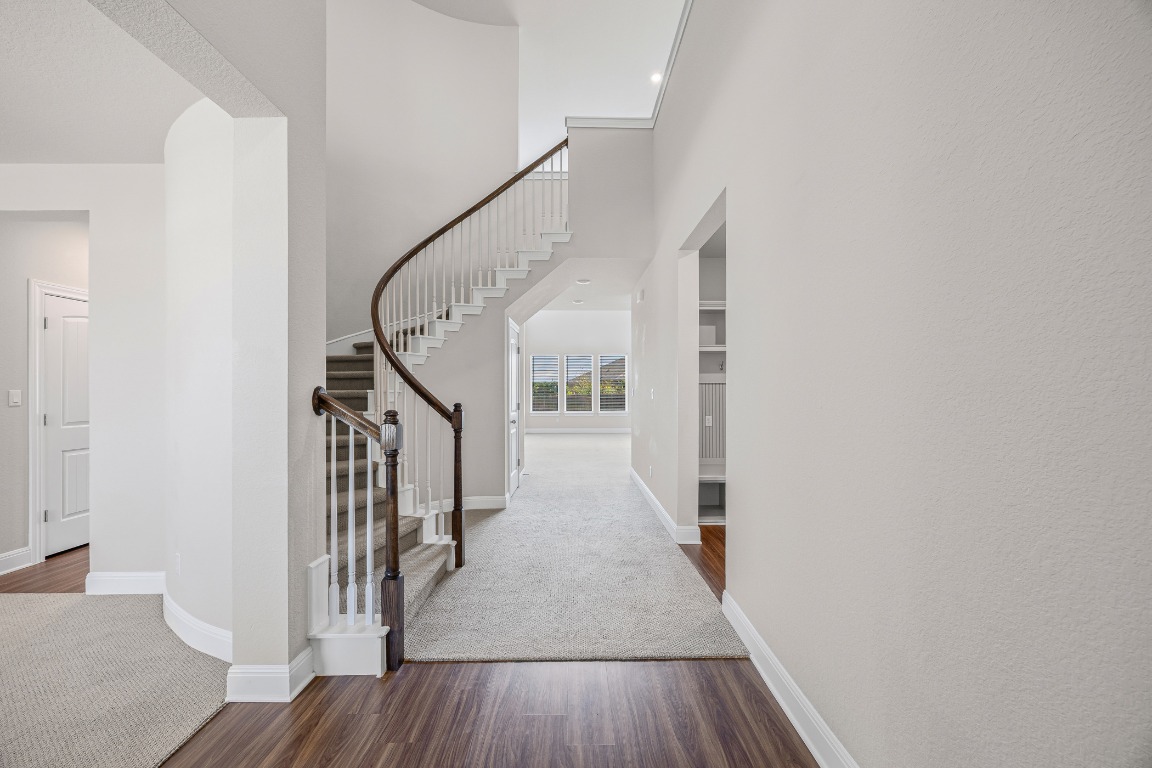 187 Glass Mountain Way Dripping Springs, TX 78620 - Photo 7 of 35 a view of a hallway with wooden floor and entryway