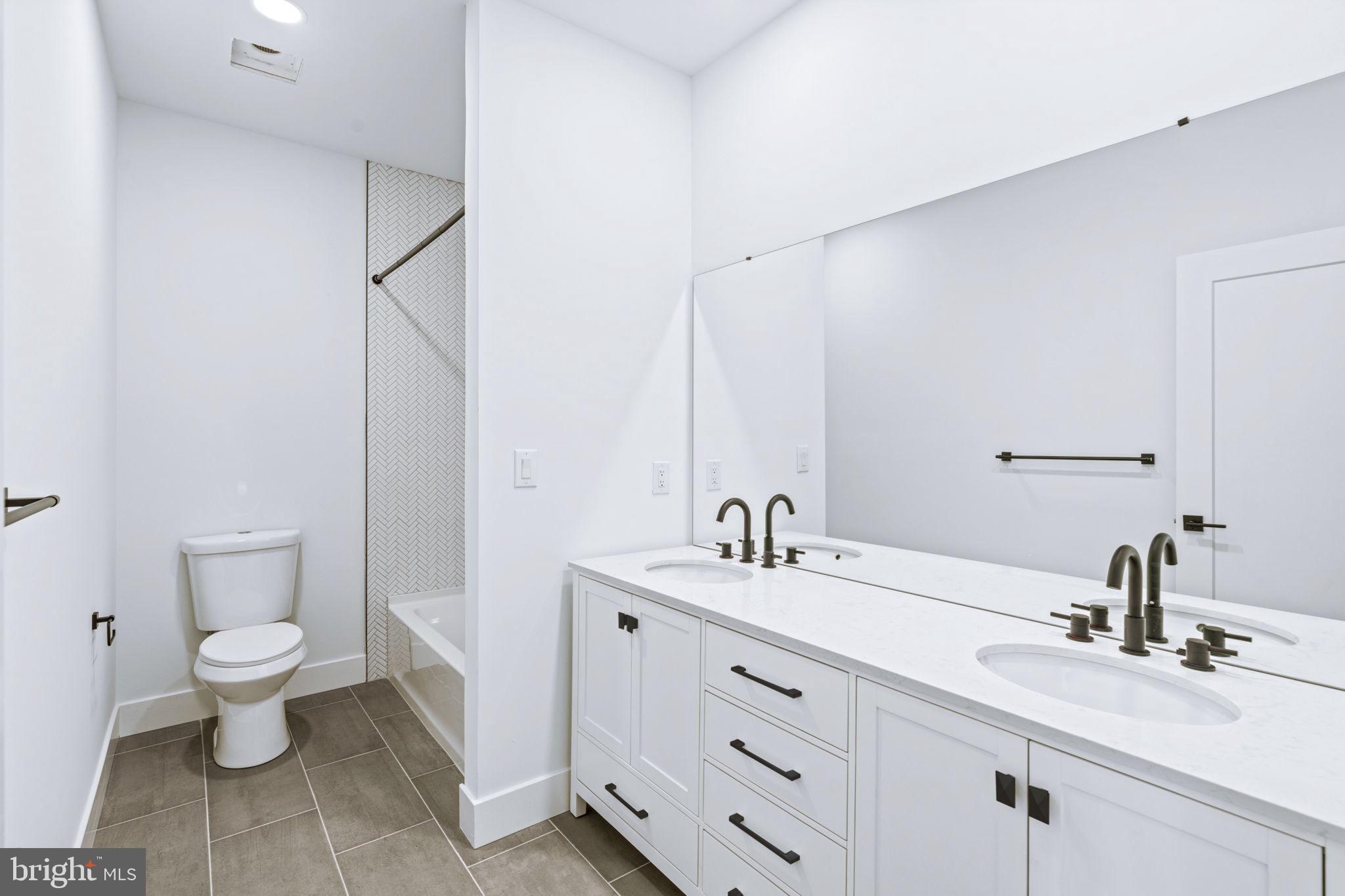 681 Provident Road Southampton, PA 18966 - Photo 15 of 33 a bathroom with a toilet sink double vanity and mirror