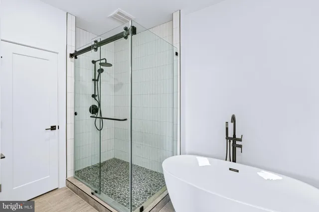 a bathroom with a shower and a sink