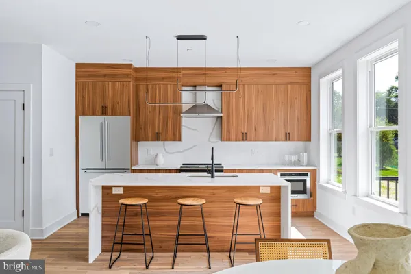 a kitchen with kitchen island granite countertop a sink and a cabinets