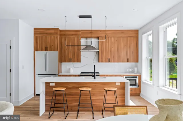 a kitchen with kitchen island granite countertop a sink and a cabinets