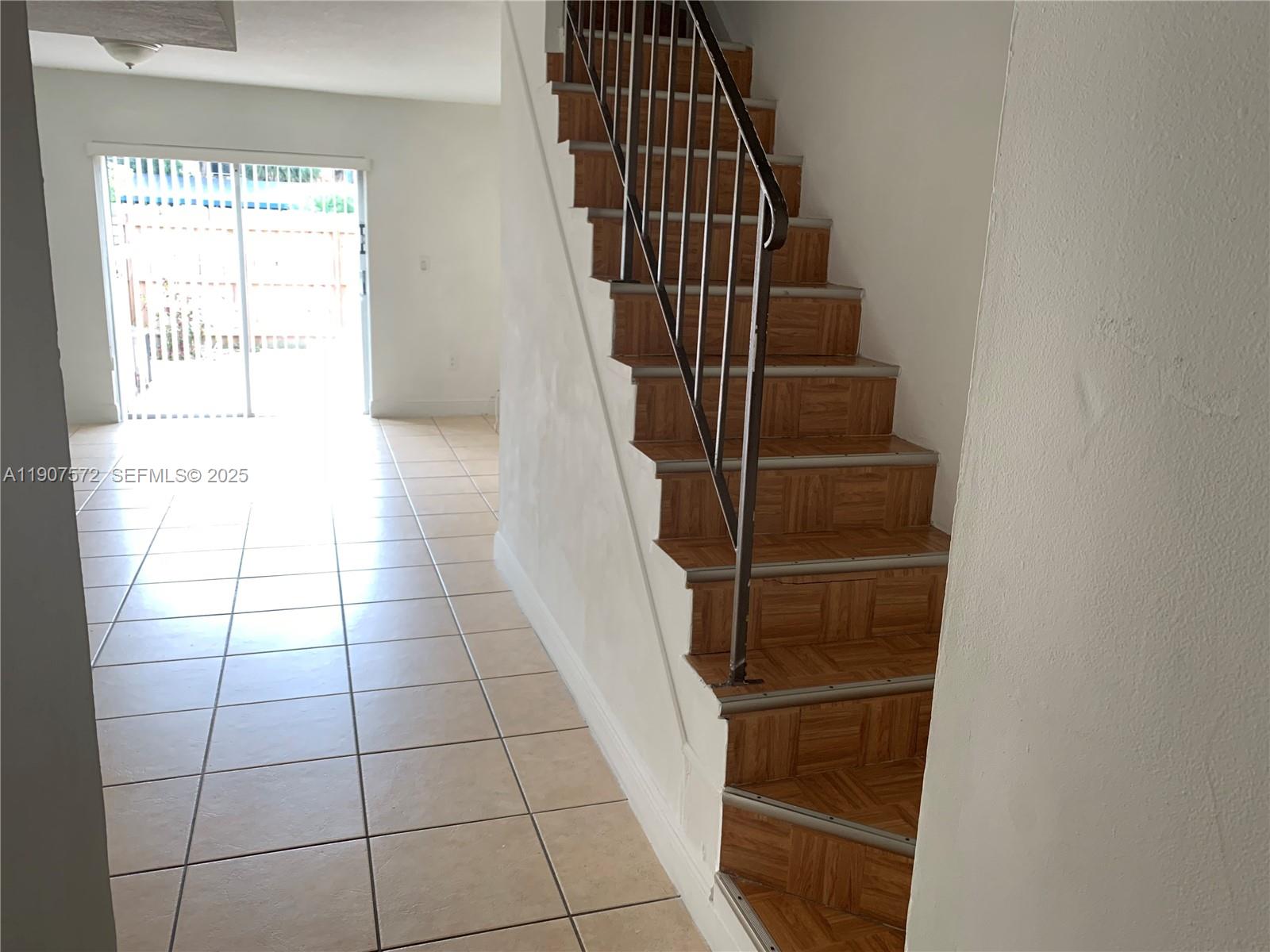 15102 Southwest 81st Street, Unit 113 Miami, FL 33193 - Photo 3 of 10 a view of entryway with wooden floor
