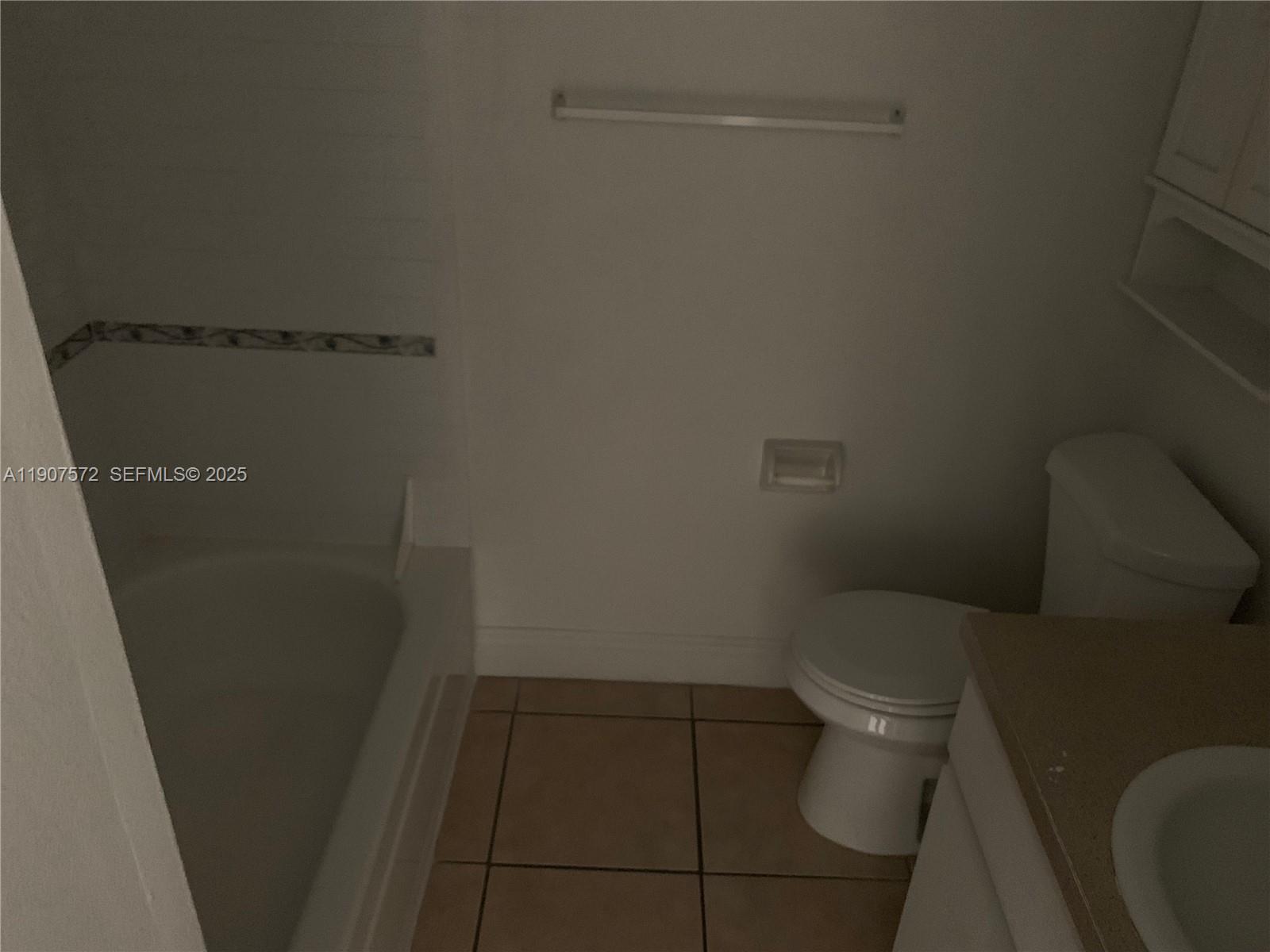 15102 Southwest 81st Street, Unit 113 Miami, FL 33193 - Photo 7 of 10 a white toilet sitting next to a shower
