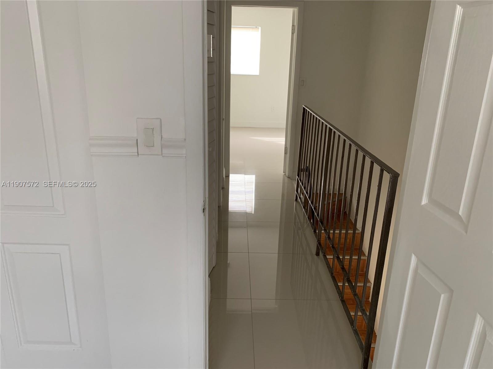 15102 Southwest 81st Street, Unit 113 Miami, FL 33193 - Photo 8 of 10 a view of a hallway with wooden floor and staircase