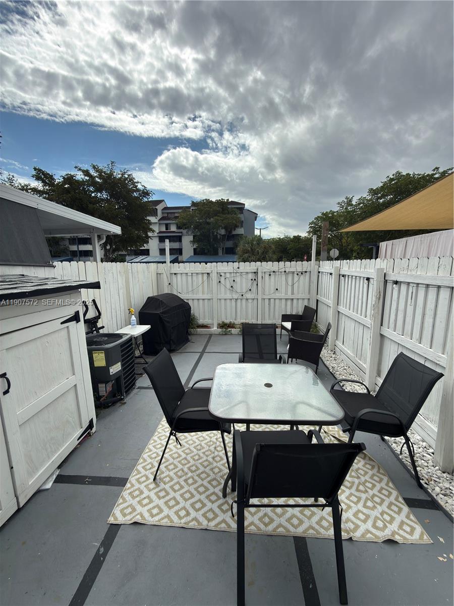 15102 Southwest 81st Street, Unit 113 Miami, FL 33193 - Photo 10 of 10 a terrace of a house with outdoor seating