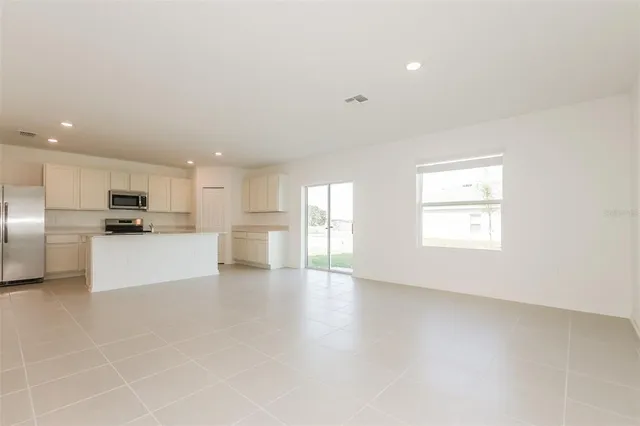 a view of kitchen with white cabinets and stainless steel appliances