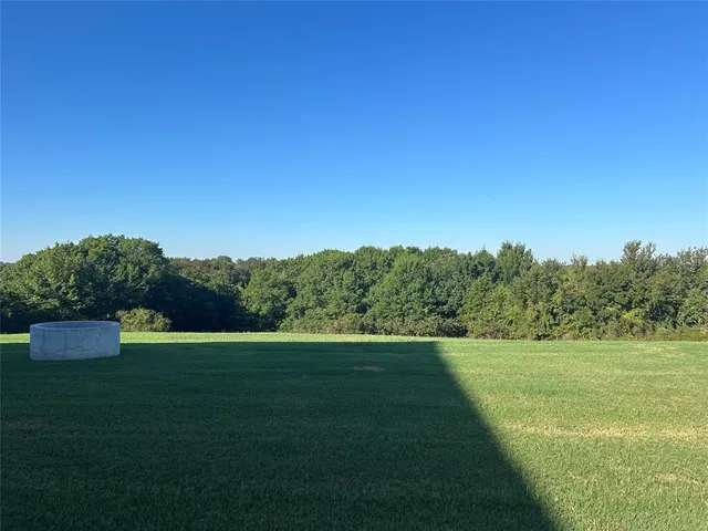 a view of a field with an ocean