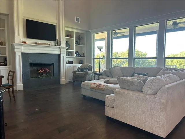 a living room with furniture fireplace and flat screen tv