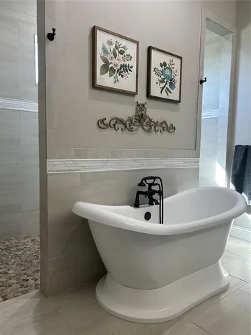 a white bath tub sitting in a bathroom