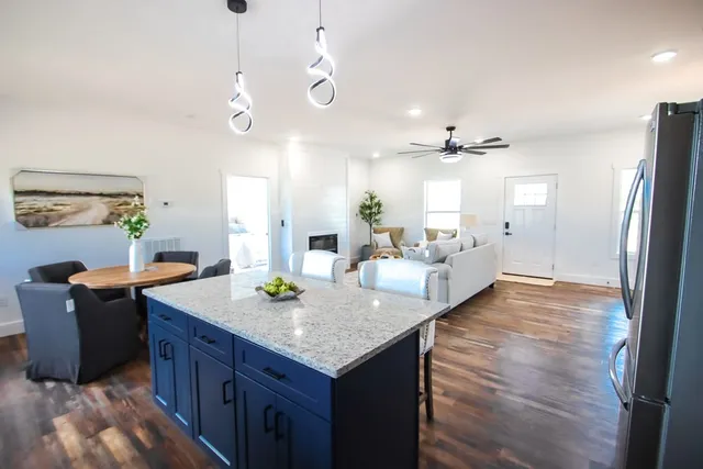 a view of kitchen island with granite countertop living room
