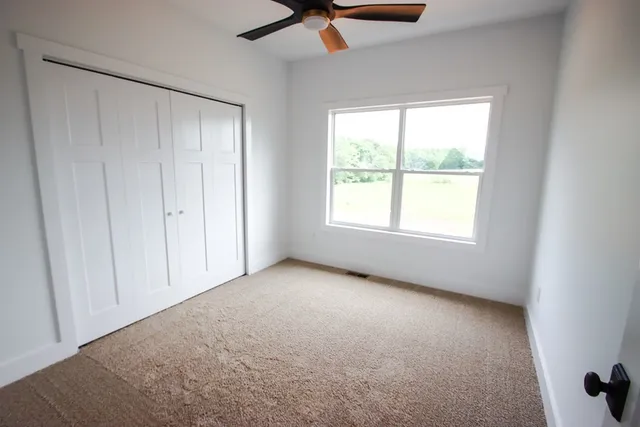 a bathroom with a granite countertop sink a toilet and a bathtub