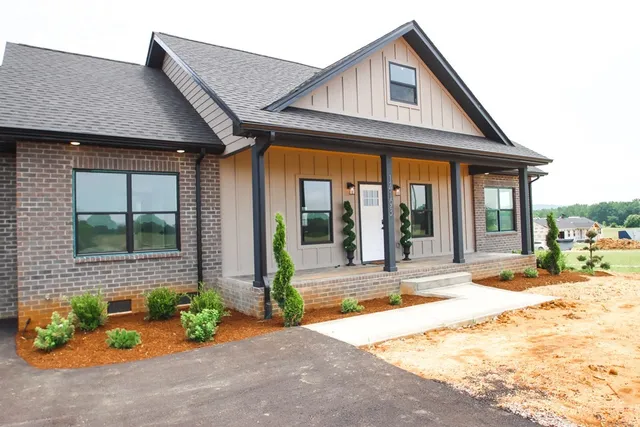 a front view of a house with a yard outdoor seating and barbeque oven