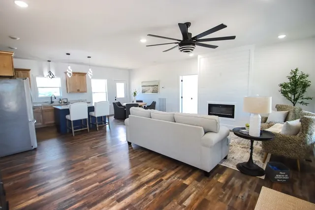 a living room with furniture and a wooden floor