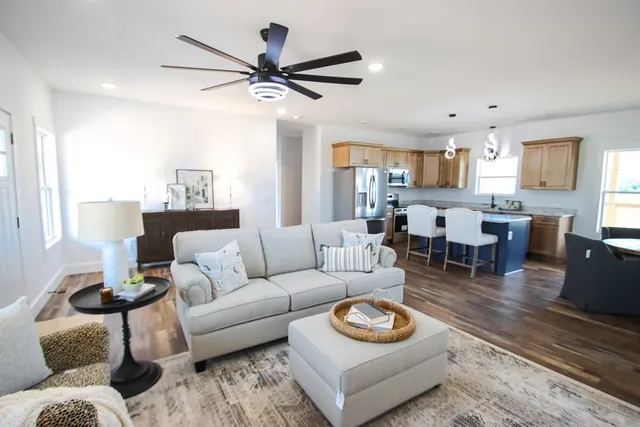 a living room with furniture and a wooden floor