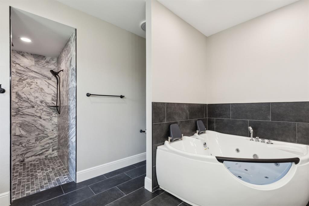 700 Brown Road Palo Pinto, TX 76484 - Photo 23 of 40 Primary bathroom with jetted tub for 2, and walk in shower.