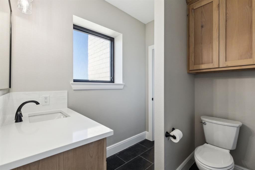 700 Brown Road Palo Pinto, TX 76484 - Photo 27 of 40 Bathroom featuring vanity, toilet, baseboards, and tile patterned floors
