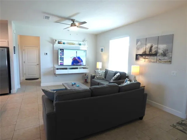 a living room with furniture a wooden floor and chandelier