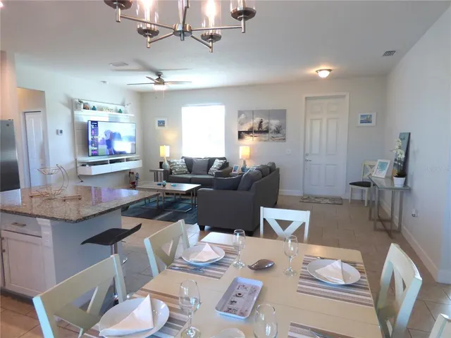 a kitchen with stainless steel appliances granite countertop a sink a stove a microwave a refrigerator and cabinets