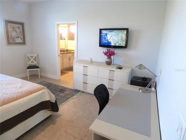 a bed room with a bed and a chair