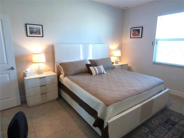 a bedroom with a bed and window