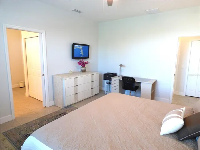a bathroom with a granite countertop double vanity sink and mirror