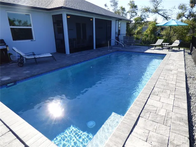 a front view of a house with a garden and plants