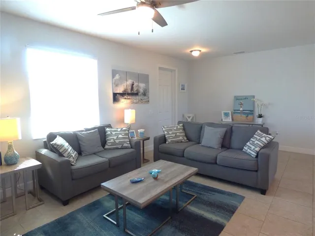 a living room with furniture and kitchen view