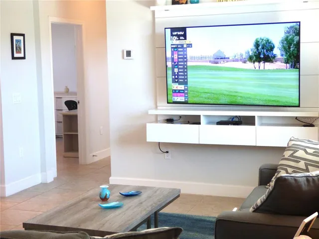 a living room with granite countertop furniture and kitchen view