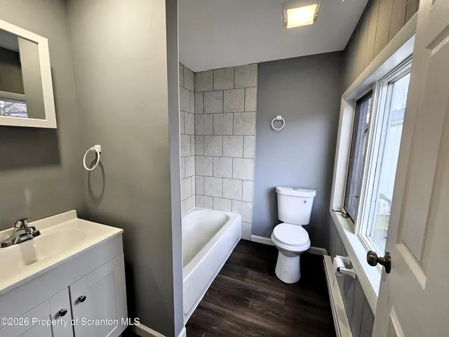 a bathroom with a toilet sink and shower