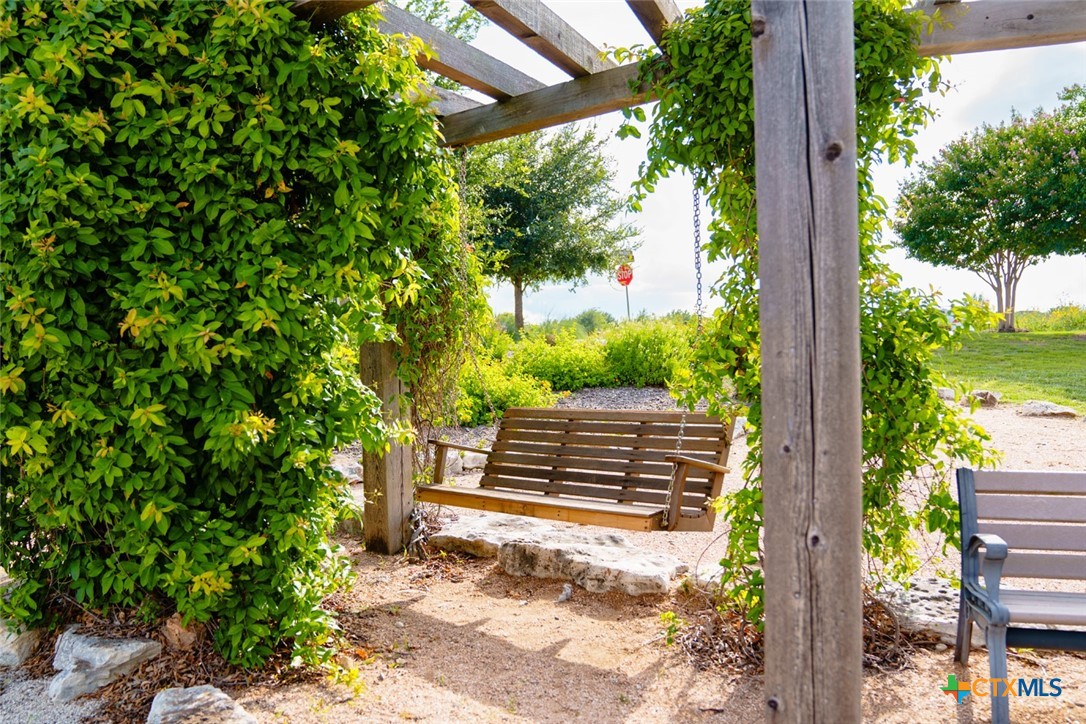 8084 Coral Draw Schertz, TX 78154 - Photo 11 of 13 a view of a yard with plants and wooden fence