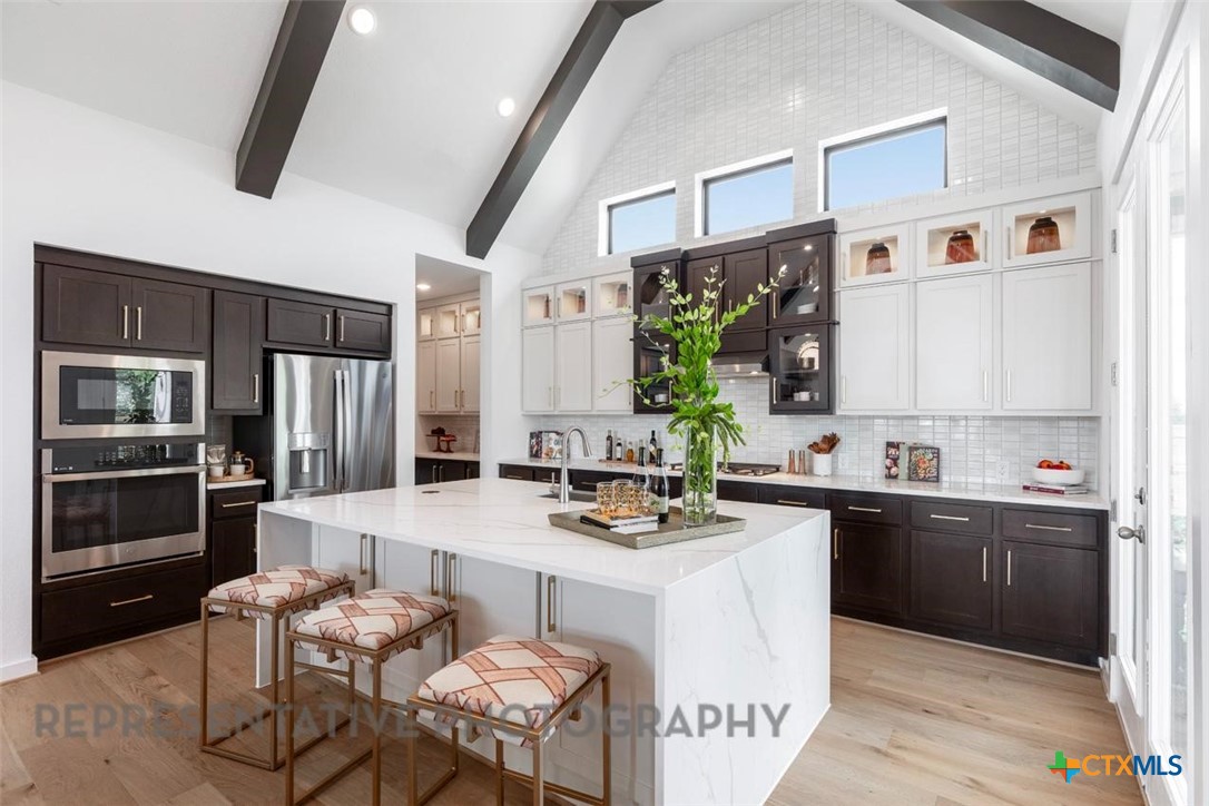 8084 Coral Draw Schertz, TX 78154 - Photo 2 of 13 a kitchen with a refrigerator a stove top oven a sink and dishwasher