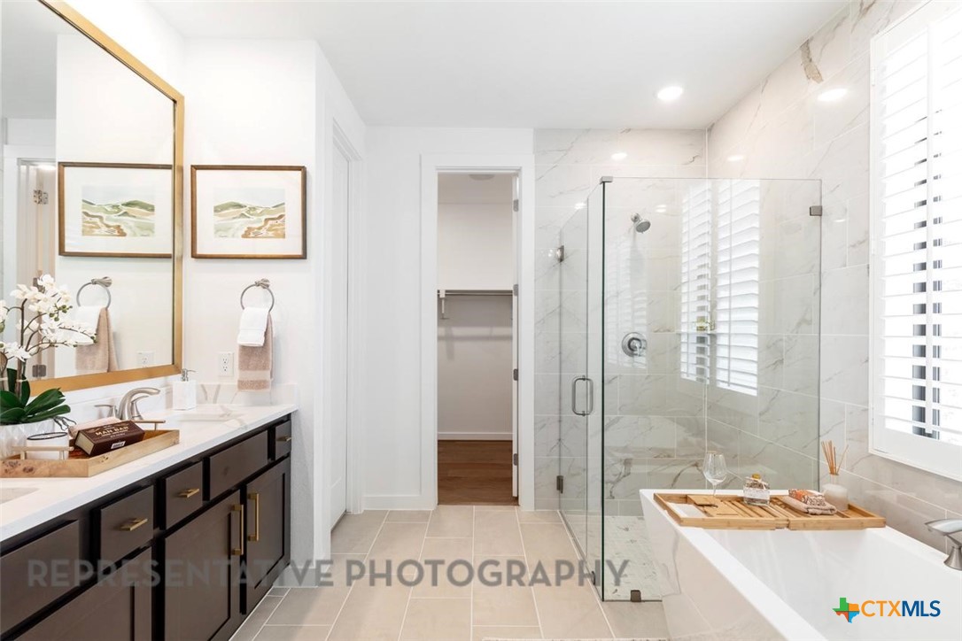 8084 Coral Draw Schertz, TX 78154 - Photo 5 of 13 a spacious bathroom with a tub sink and mirror
