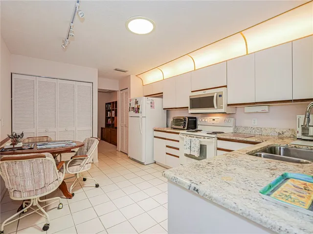 a kitchen with stainless steel appliances granite countertop a sink and a stove