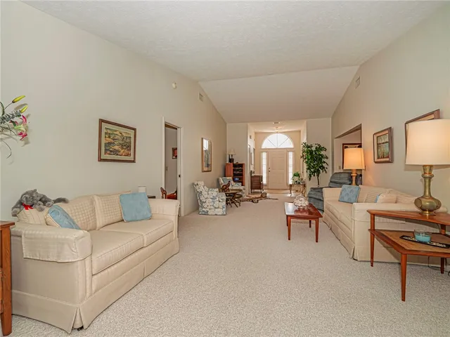a living room with furniture a lamp and a table