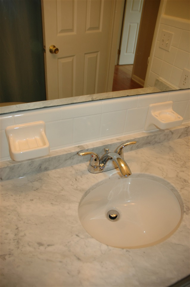 716 Currituck Drive Raleigh, NC 27609 - Photo 15 of 19 Remodeled bath with Tub/Shower combo, white cabinets, marble counters, & new chrome faucet and sink. Hall Bath
