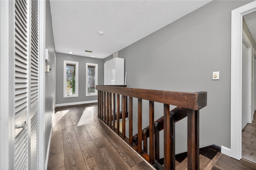 4747 Fawnwood Road Dayton, OH 45429 - Photo 36 of 58 This interior hallway features rich hardwood flooring and abundant natural light from multiple windows.