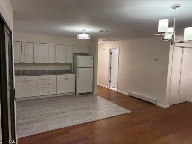 a view of a kitchen with wooden floor