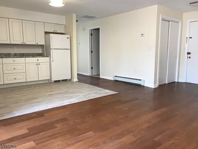 a view of kitchen with wooden floor