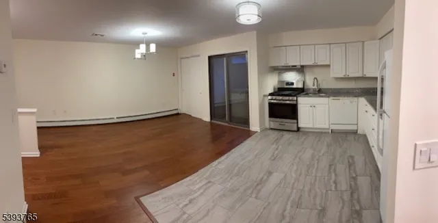 a kitchen with granite countertop stainless steel appliances and wooden cabinets