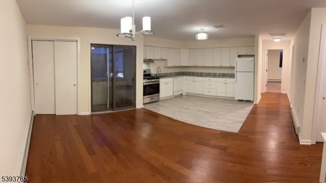 a view of kitchen with wooden floor