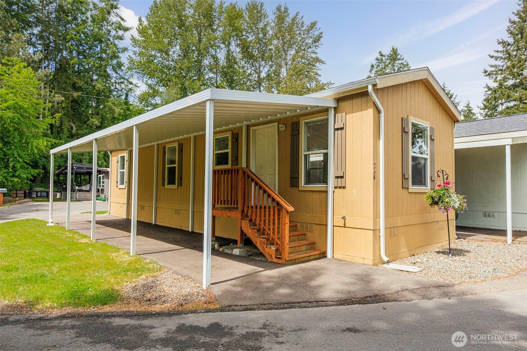 a view of a house with wooden walls and a yard