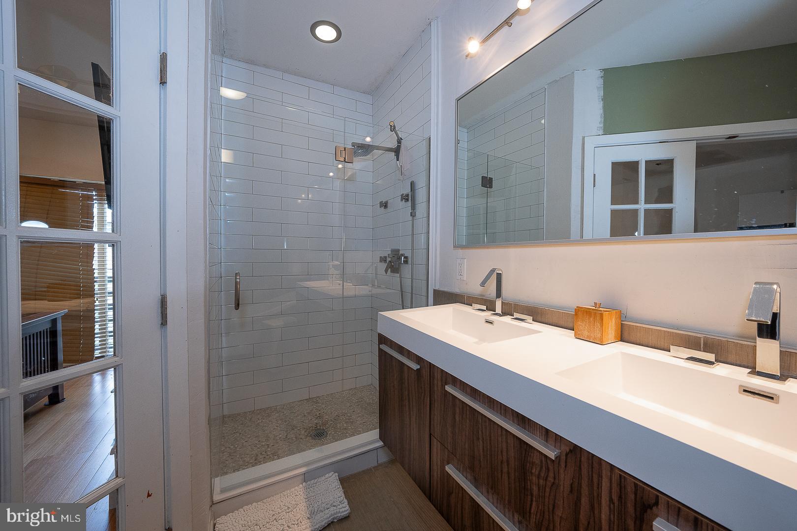 715 Shirley Street, Unit A Philadelphia, PA 19130 - Photo 21 of 24 a bathroom with a sink and a mirror