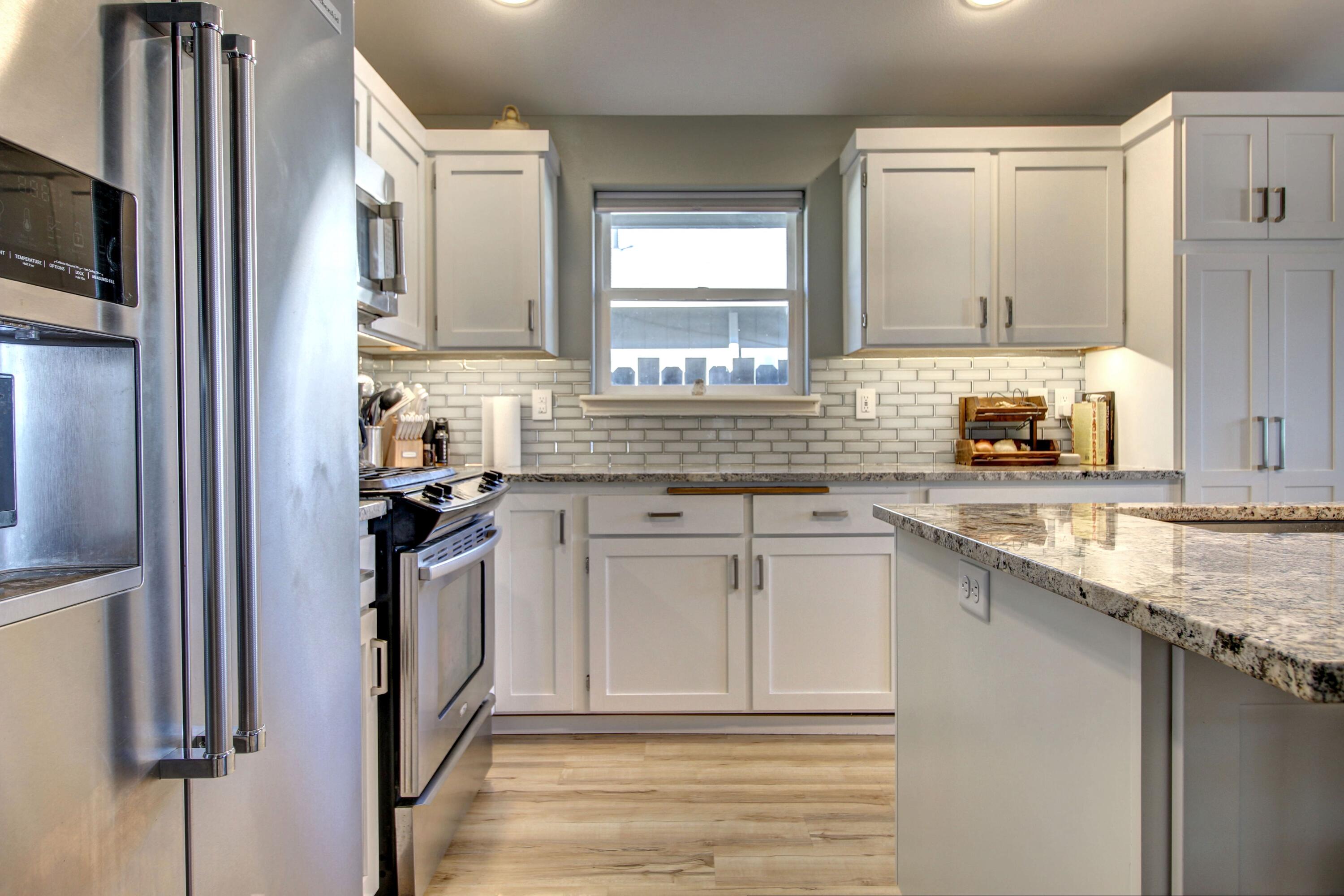 2683 Merriman Road Medford, OR 97501 - Photo 9 of 23 a kitchen with stainless steel appliances granite countertop a sink stove and refrigerator